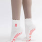Pink Gummy Bear on Ruffled Cream Pilates Grip Sock
